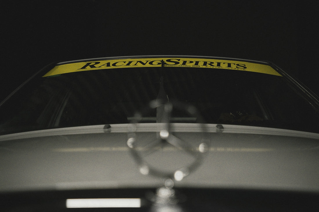Car hood emblem with racing banner