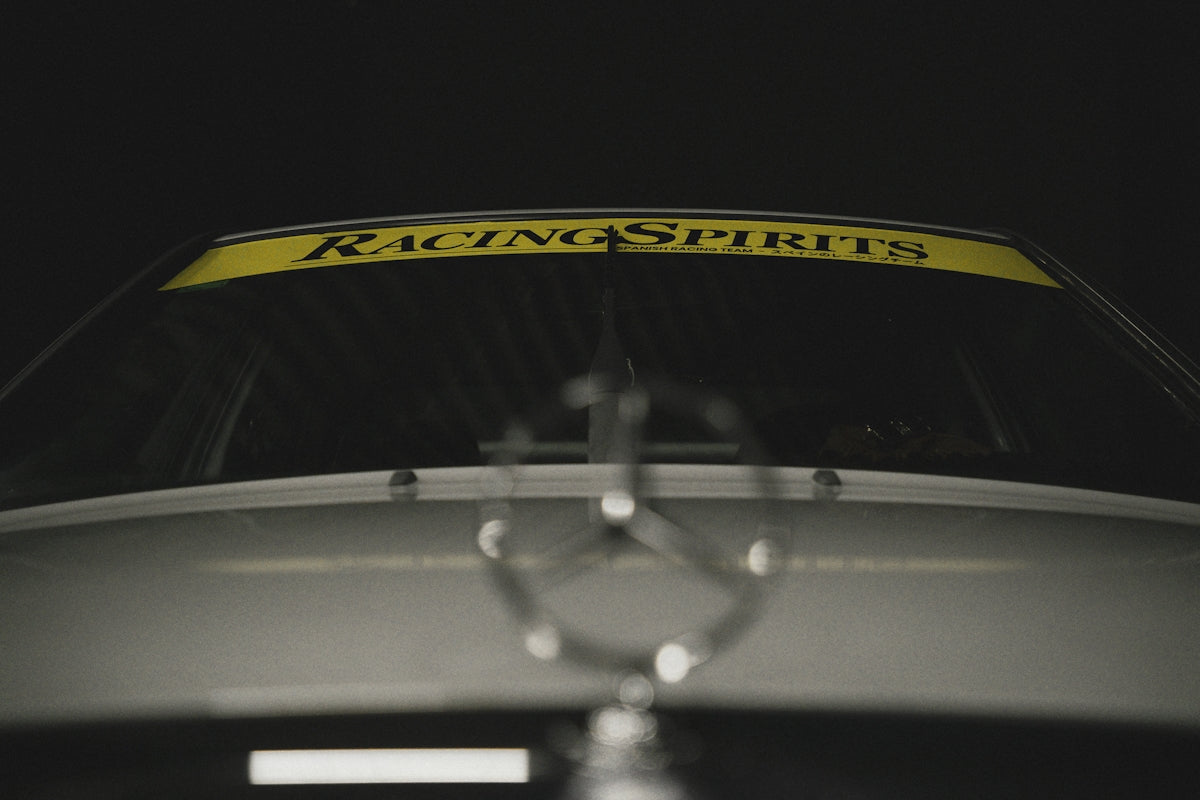 Car hood emblem with racing banner